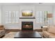 Living room fireplace with hearth, white shuttered windows and bright natural light at 5971 Brundage Lane, Norcross, GA 30071