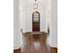Bright foyer with hardwood floors, arched front door, and a glimpse of the bathroom at 5971 Brundage Lane, Norcross, GA 30071