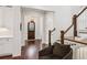 Elegant foyer with hardwood floors, shiplap accent wall, and arched doorway view at 5971 Brundage Lane, Norcross, GA 30071