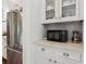 Bright kitchen area showcases stainless Viking fridge and white cabinets with microwave and tiled backsplash at 5971 Brundage Lane, Norcross, GA 30071
