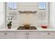 Close up of cooktop, marble backsplash, and cabinetry at 5971 Brundage Lane, Norcross, GA 30071