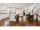 Open-concept design featuring a large kitchen island with hardwood floors and staircase at 5971 Brundage Lane, Norcross, GA 30071