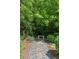 Peaceful landscaping and stone path with bench create a serene backyard retreat at 5971 Brundage Lane, Norcross, GA 30071