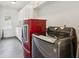 Spacious laundry room with washer and dryer, plus white cabinets and shelving at 5971 Brundage Lane, Norcross, GA 30071