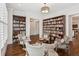 Well-lit living room featuring bookshelves, hardwood floors and a stylish seating arrangement at 5971 Brundage Lane, Norcross, GA 30071