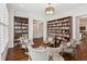 Elegant living room featuring custom bookshelves, comfortable seating, and hardwood floors at 5971 Brundage Lane, Norcross, GA 30071