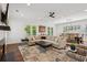 Open concept living and dining area, featuring hardwood floors and a large sectional sofa at 5971 Brundage Lane, Norcross, GA 30071