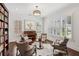 Cozy living room featuring a piano, bookshelves, and comfortable seating arrangement at 5971 Brundage Lane, Norcross, GA 30071