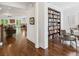 Open-concept living room with hardwood floors and built-in bookshelf at 5971 Brundage Lane, Norcross, GA 30071