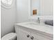 A well-lit powder room features white cabinets and stone countertops at 5971 Brundage Lane, Norcross, GA 30071