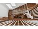 Grand staircase with hardwood steps, white risers, and white spindles at 5971 Brundage Lane, Norcross, GA 30071