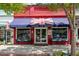 Taste of Britain storefront featuring British flag, outdoor seating, and window displays at 5971 Brundage Lane, Norcross, GA 30071