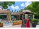 Ice cream shop exterior with outdoor seating, decorative pergola, and visible signage at 5971 Brundage Lane, Norcross, GA 30071