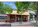 Inviting storefront with brick facade, awning, outdoor seating, and large windows displaying the interior at 5971 Brundage Lane, Norcross, GA 30071
