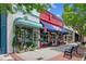 Charming storefront with colorful awnings, potted plants, and outdoor seating, creating a welcoming ambiance at 5971 Brundage Lane, Norcross, GA 30071