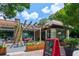 Butter & Cream storefront featuring a pergola, outdoor seating, and an inviting chalkboard sign at 5971 Brundage Lane, Norcross, GA 30071
