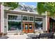 Attractive storefront with large windows, wooden doors, and decorative planters, creating a welcoming entrance at 5971 Brundage Lane, Norcross, GA 30071