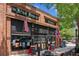 Exterior view of The Iron Horse Tavern, a brick building with flags and outdoor seating at 5971 Brundage Lane, Norcross, GA 30071