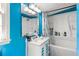 Blue bathroom featuring a vanity, a sink, a mirror, a tub, and a shower at 1151 Sheppard Pl, Stone Mountain, GA 30083