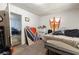 A bedroom with an open doorway, a bed with bedding, and disorganized personal items on a carpeted floor at 1151 Sheppard Pl, Stone Mountain, GA 30083