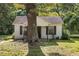 Charming home exterior showcasing the front yard and a mature tree providing shade at 1151 Sheppard Pl, Stone Mountain, GA 30083