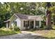 Charming home exterior showcasing the front yard and a mature tree providing shade at 1151 Sheppard Pl, Stone Mountain, GA 30083