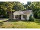 Charming home exterior showcasing the front yard and a mature tree providing shade at 1151 Sheppard Pl, Stone Mountain, GA 30083