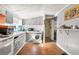 Kitchen features grey cabinetry, appliances, a washing machine, and laminate flooring at 1151 Sheppard Pl, Stone Mountain, GA 30083