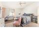 Cozy bedroom with neutral carpet, ceiling fan, large window, and ample natural light at 1523 Dillard Rd, Stone Mountain, GA 30088