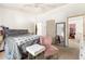 Bright bedroom featuring a ceiling fan and a comfortable bed with stylish accents at 1523 Dillard Rd, Stone Mountain, GA 30088