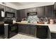 Galley kitchen with black cabinets, modern appliances, mosaic backsplash, and white countertops at 1523 Dillard Rd, Stone Mountain, GA 30088