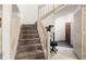 Carpeted staircase leading to the upper level of the home with sidelight at 1523 Dillard Rd, Stone Mountain, GA 30088