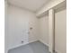 A basement room with painted floors, a white support beam, and unfinished washer and dryer hookups at 2254 Glendale Dr, Decatur, GA 30032