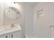 Bathroom featuring white subway tile, vanity, and a round mirror at 2254 Glendale Dr, Decatur, GA 30032