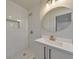 Bathroom featuring white subway tile, vanity, and a round mirror at 2254 Glendale Dr, Decatur, GA 30032