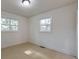 This bedroom features two windows that provide natural light and newly refinished wood floors at 2254 Glendale Dr, Decatur, GA 30032