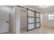 Bedroom featuring modern barn door closet, window, complemented by white walls and light wood floors at 2254 Glendale Dr, Decatur, GA 30032