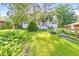 Charming two-story home featuring a lush, green front yard and natural landscaping at 2254 Glendale Dr, Decatur, GA 30032