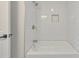This shower has a subway tile surround, gold hardware and a corner shelf for toiletries at 2254 Glendale Dr, Decatur, GA 30032