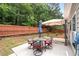 Backyard with a patio set, new grass, wooden fence, and privacy provided by mature trees at 320 Roland Manor Dr, Dacula, GA 30019