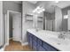 Bathroom features double sink vanity and shower with glass doors at 320 Roland Manor Dr, Dacula, GA 30019