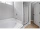 Bathroom features white soaking tub and separate glass enclosed shower at 320 Roland Manor Dr, Dacula, GA 30019