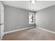 Neutral bedroom featuring natural light and neutral carpet at 320 Roland Manor Dr, Dacula, GA 30019