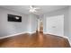 Spacious bedroom features wood floors, ceiling fan, TV, and ensuite bathroom at 320 Roland Manor Dr, Dacula, GA 30019