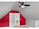 Upstairs bonus room with vaulted ceilings, ceiling fan, and door leading to a bedroom area with carpet at 320 Roland Manor Dr, Dacula, GA 30019