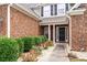 Close-up of the front entrance with brick facade and landscaped garden at 320 Roland Manor Dr, Dacula, GA 30019