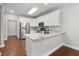 Bright kitchen features white cabinets, stainless steel appliances, and granite countertops at 320 Roland Manor Dr, Dacula, GA 30019