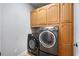 Convenient laundry room with a washer, dryer, and storage cabinets at 320 Roland Manor Dr, Dacula, GA 30019
