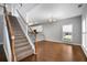 Living Room features stairway with railing and view to open concept kitchen at 320 Roland Manor Dr, Dacula, GA 30019