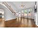 Large living area features hardwood floors and staircase at 320 Roland Manor Dr, Dacula, GA 30019